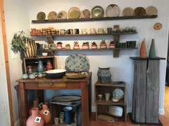 clay pieces displyed on wall and shelves by mayne island clay works on Mayne Island British Columbia